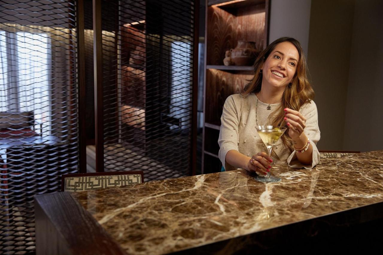 Sheraton Lima Historic Center Exterior photo A woman drinking champagne